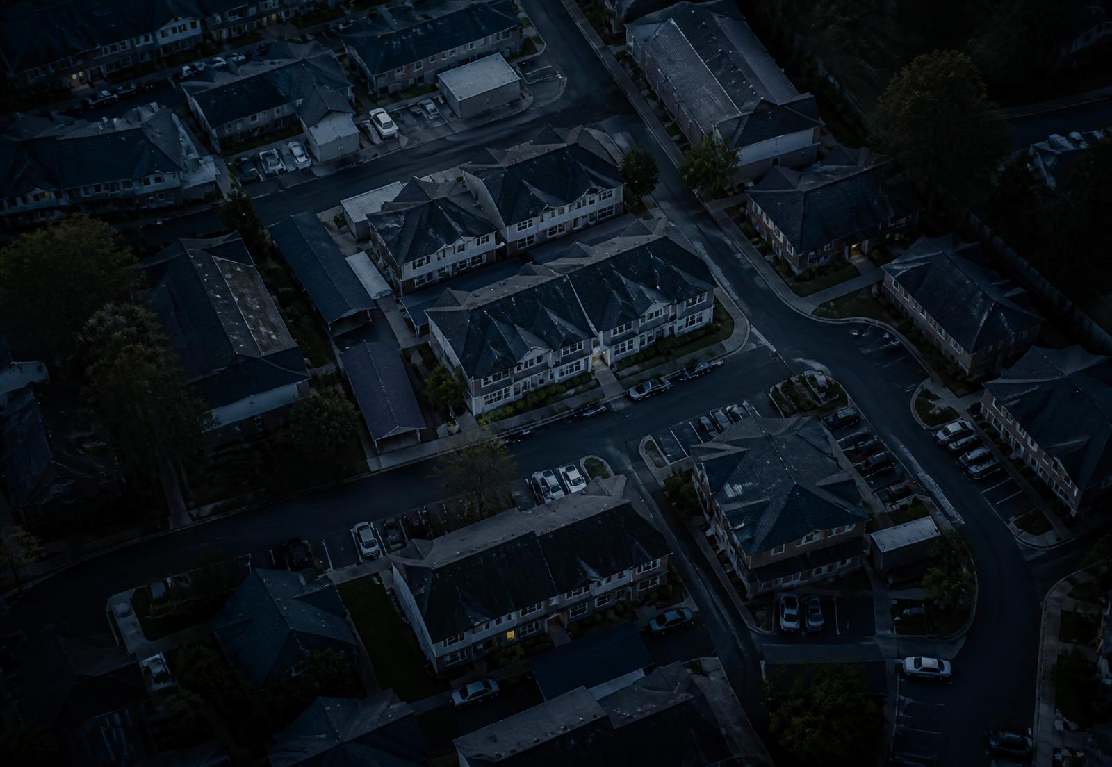 Aerial view of a multifamily housing neighborhood at twilight